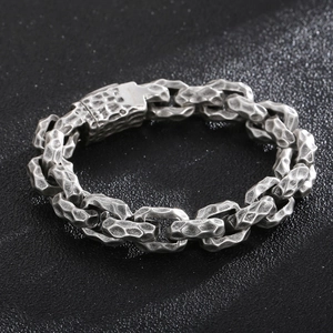 Detail of vintage silver hammered stainless steel heavy chain bracelet with matte finish