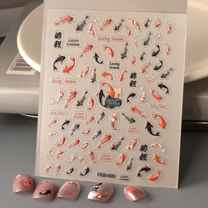 Macro detail of 3D koi fish nail stickers with Lucky Charm text on lilac manicure base