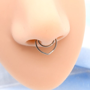 Close-up of double-layer heart shaped silver nose ring on a realistic nose model