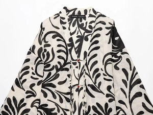 Detail of black and white plant print kimono cardigan with textured lightweight fabric