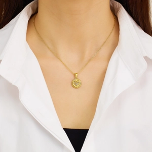 Golden stainless steel necklace featuring a hollow round pendant with sparkling heart inlay