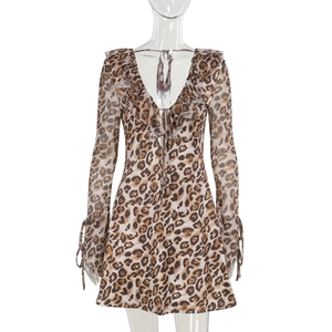 Detail of leopard print mini dress featuring ruffled V-neckline and drawstring sleeve ties