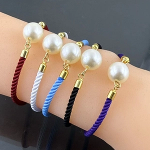 Adjustable woven rope bracelet set with large imitation pearls and gold finish details