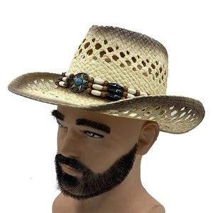 Detail of straw cowboy hat featuring ethnic bead band and turquoise star badge
