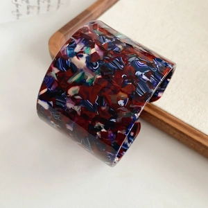 Macro detail of vintage acetate open cuff bracelet with colorful abstract resin patterns