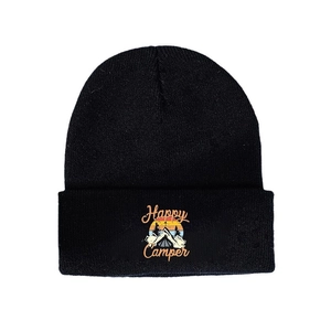 Black knit beanie with a Happy Camper sunset and mountain patch on a plain white background