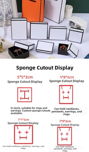 Detail view of jewelry gift boxes with foam inserts in multiple sizes and orange paper bags