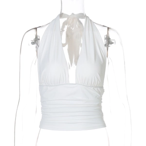 Detail of white halter neck top with cross-wrap design on a mannequin display