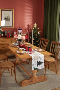 Detailed view of woven chair cushion and solid wood table legs in a festive setting