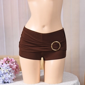 Detail of dark brown low-waisted shorts featuring decorative gold metal rings on the hip