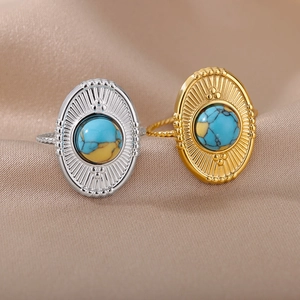 Detail view of vintage sunburst rings with turquoise stones in gold and silver finish