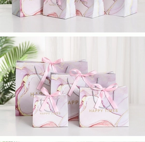Detail of marble pattern gift bags with ribbon handles in various sizes for packaging