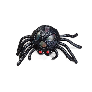 Halloween black spider stress relief toy with red eyes and colorful bubbles on white background