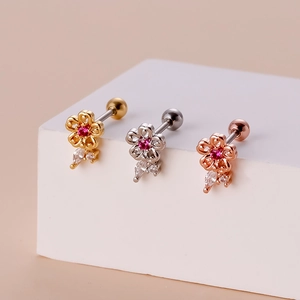 Detailed view of flower stud earrings in gold, silver, and rose gold with pink gems