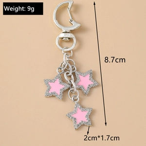Detail view of silver keychain with three pink rhinestone stars and dimension labels