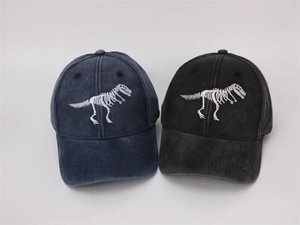 Detail view of navy and black washed cotton baseball caps with white dinosaur bone embroidery