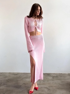 Pink knit two-piece set featuring lace-up long sleeve cardigan and side slit maxi skirt