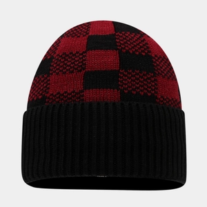 Close-up of knit beanie featuring red and black checkerboard pattern with ribbed cuff