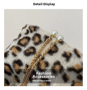 Detail of leopard print faux fur bag with golden chain and elegant pearl charms