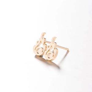 Detail of gold hollow swirl stud earrings with artistic flame-shaped cutout design