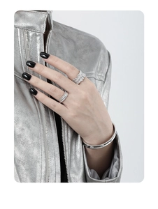 Matte silver bangle and sparkling ring set shown on hand with silver leather jacket