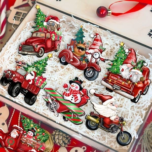 Detail of Christmas wooden pendants featuring Santa and gnome in a clear gift box