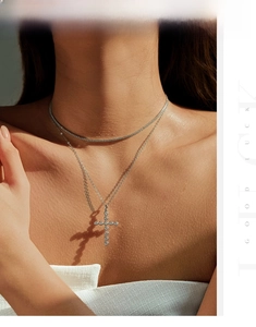 Close-up of a layered S925 silver tennis chain and cross pendant necklace on neck
