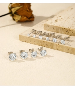 Close-up of classic 2ct moissanite stud earrings in S925 sterling silver on stone base