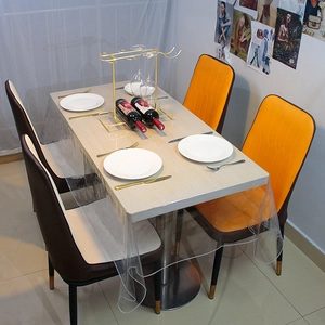 Modern rectangular table with clear 12-silk PVC tablecloth and orange dining chairs