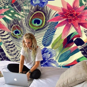 Tropical bohemian wall tapestry featuring exotic birds and floral patterns in a cozy bedroom