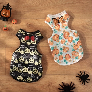 Close-up of Halloween pet dresses with pumpkin prints and sequined bat bow details