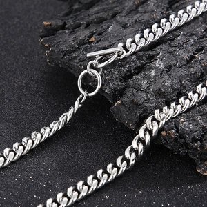 Macro shot of silver stainless steel Cuban chain necklace with a T-bar toggle clasp