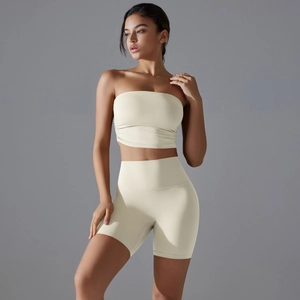 Detail of ruched bandeau top and high-waisted shorts in cream yoga fitness set