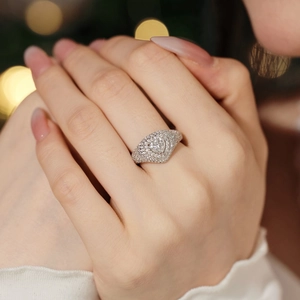 Close-up of a luxury S925 silver heart ring with sparkling cubic zirconia on a hand