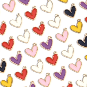 Close-up of colorful heart charms with gold metal edges and enamel oil finish for DIY