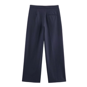 Detail view of the vertical pinstripe texture on dark blue wide leg suit trousers
