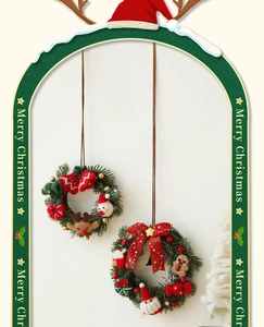Close-up of Merry Christmas wall wreaths with red berries and green pine needles