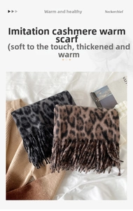 Detail of leopard print faux cashmere scarves with long fringes and thick winter texture