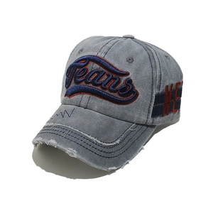 Detailed close-up of vintage washed denim baseball cap with 3D Jeans embroidery