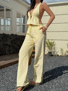 Detail of yellow and white striped halter top and trousers set for summer vacation