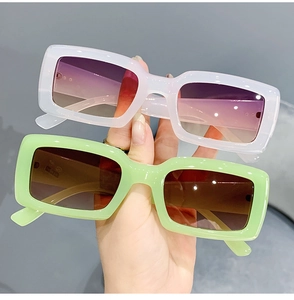 Detail of trendy rectangle sunglasses in purple and green with high-quality plastic frames