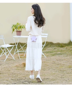 Outdoor shot of a purple star-shaped PVC jelly crossbody bag with a gold chain strap