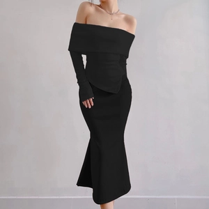 Detail of black off-shoulder knitted long sleeve top and mermaid maxi skirt set