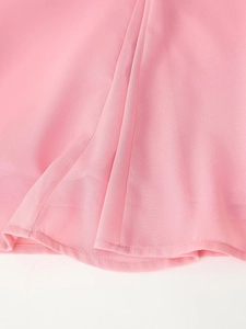 Detailed close-up showing texture of pink chiffon fabric and delicate layered ruffles