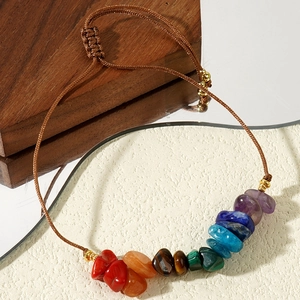 Macro detail of handmade wax cord bracelet with citrine and tiger eye natural stones