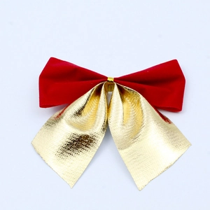 Detailed close-up of decorative red velvet and gold metallic Christmas tree bows