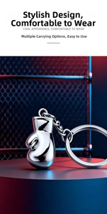 Polished silver metal boxing glove keychain with realistic texture on a display stand