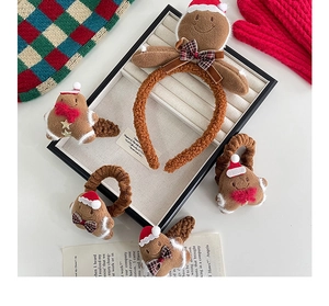 Detail of plush gingerbread man headband and hair clips for Christmas accessories