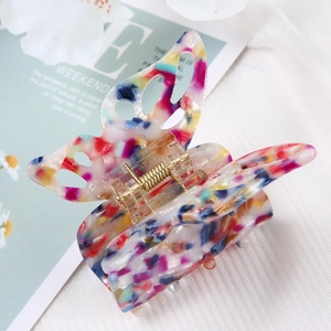 Detailed view of the acetate butterfly hair claw clip with colorful marble pattern