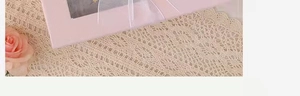 Detailed macro view of a pink window gift box with a delicate white ribbon and lace